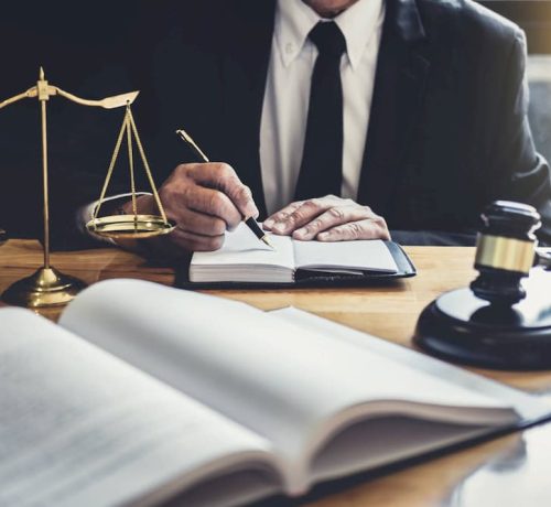 male-lawyer-or-judge-working-with-contract-papers-5ZV28KL