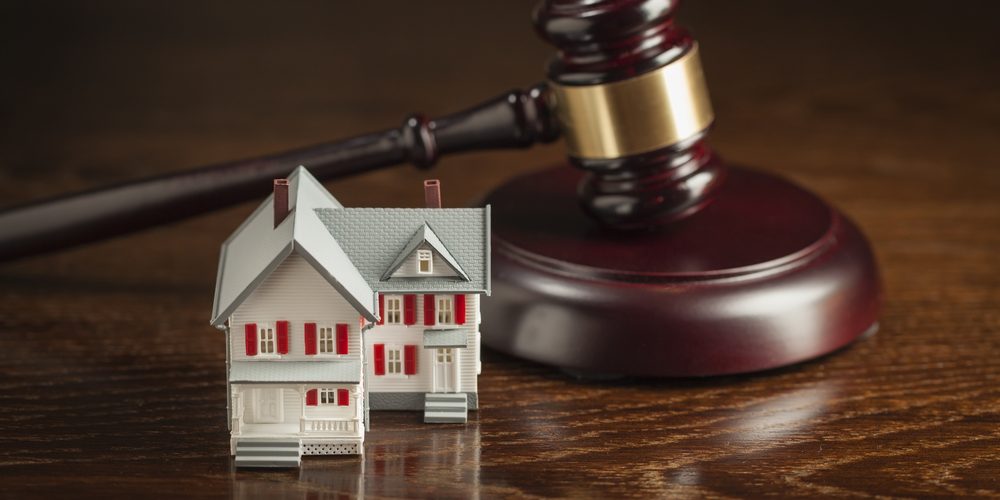 Gavel,And,Small,Model,House,On,Wooden,Table.